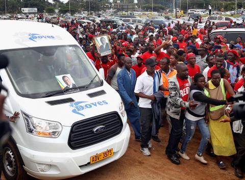 Mourners watch as the coffin passes at the funeral parade held for the late Movement For Democratic Change (MDC) leader Morgan Tsvangirai in Harare, Zimbabwe, February 19, 2018. PHOTO BY REUTERS/Philimon Bulawayo