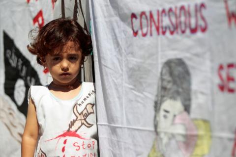 An Iraqi Yazidi refugee girl attends a commemoration of the third anniversary of the Yazidi genocide in Sinjar region, in the village of Nea Apollonia where more than 400 Yazidis live in apartments provided by a UNHCR-sponsored housing scheme, near Thessaloniki, Greece, August 3, 2017. PHOTO BY REUTERS/Alexandros Avramidis