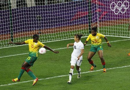 New Zealand's Sarah Gregorius (C) watches as Cameroon's Ysis Sonkeng (L) scores an own goal during their women's football first round Group E match at the City of Coventry Stadium during the London 2012 Olympic Games July 31, 2012. Cameroon's Augustine Ejangue is at right. PHOTO BY REUTERS/Alessandro Garofalo