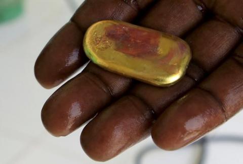 A trader shows a piece of gold at his shop in the town of Al-Fahir in North Darfur. PHOTO BY REUTERS/Mohamed Nureldin Abdallah