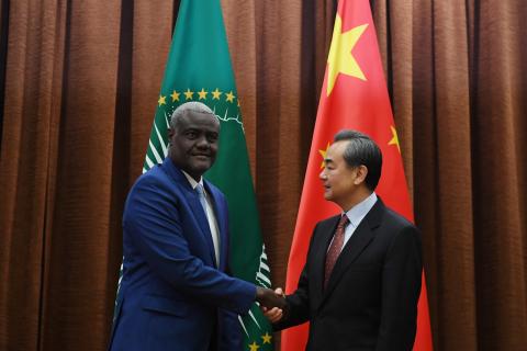 African Union Commission Chairperson Moussa Faki Mahamat (L) shakes hands with Chinese Foreign Minister Wang Yi before a meeting in Beijing, China, February 8, 2018. PHOTO BY REUTERS/Greg Baker