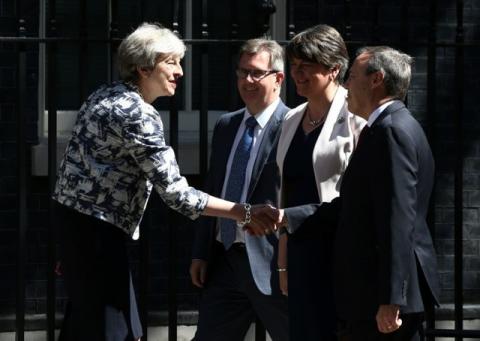 Britain's Prime Minister, Theresa May, shakes hands with Democratic Unionist Party (DUP) Deputy Leader Nigel Dodds, in Downing Street, in central London, Britain, June 26, 2017. PHOTO BY REUTERS/Neil hall