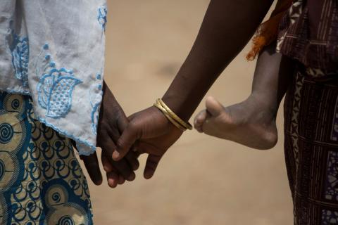Fifteen year-old Nigerian refugee Fati, walks with her mother, Mariam, while carrying her sister at the Minawao refugee camp in Northern Cameroon. PHOTO BY REUTERS/Karel Prinsloo/UNICEF