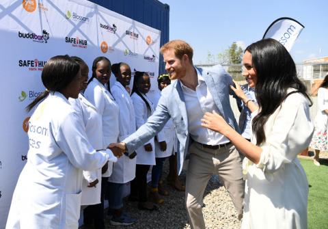 Britain's Prince Harry and his wife Meghan, the Duke and Duchess of Sussex, speak to people at the Youth Employment Services (YES) Hub as they visit a township in Johannesburg, South Africa, October 2, 2019. PHOTO BY REUTERS/Facundo Arrizabalaga