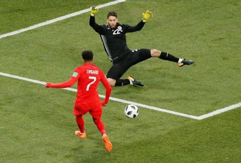 England's Jesse Lingard in action with Tunisia's Mouez Hassen. PHOTO BY REUTERS/Gleb Garanich