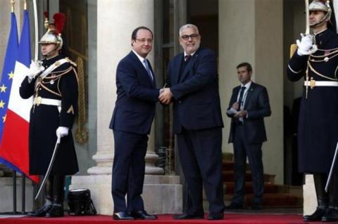 France's President Francois Hollande (L) greets Morocco's Prime Minister Abdelilah Benkirane in the courtyard of the Elysee Palace at the start of the Elysee Summit for Peace and Security in Africa, in Paris