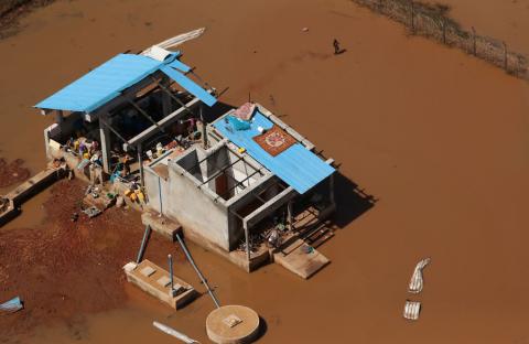 A woman walks past a small concrete slaughterhouse as waters begin to recede in the aftermath of Cyclone Idai, in Buzi near Beira, Mozambique, March 24, 2019. PHOTO BY REUTERS/Mike Hutchings
