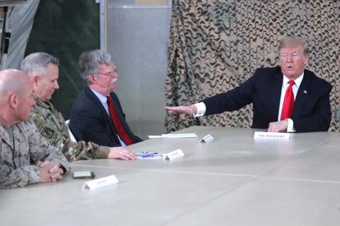 U.S. President Donald Trump, flanked by National Security Adviser John Bolton, meets political and military leaders during an unannounced visit to Al Asad Air Base, Iraq, December 26, 2018. PHOTO BY REUTERS/Jonathan Ernst