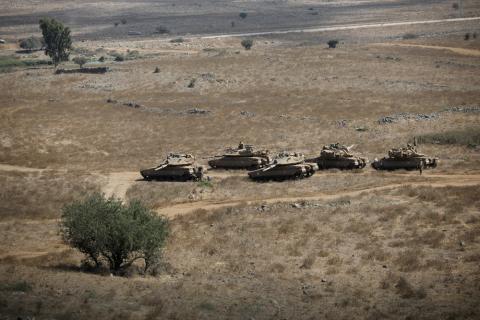 An Israeli soldier rides an armoured vehicle during an army drill after the visit of Israeli Defence Minister Avigdor Lieberman in the Israeli-occupied Golan Heights, Israel, August 7, 2018. PHOTO BY REUTERS/Amir Cohen