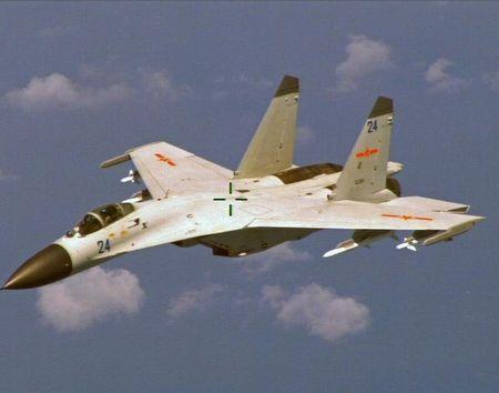 A Chinese J-11 fighter jet is seen flying near a U.S. Navy P-8 Poseidon about 215 km (135 miles) east of China's Hainan Island in this U.S. Department of Defense handout photo taken August 19, 2014. PHOTO BY REUTERS/U.S. Navy