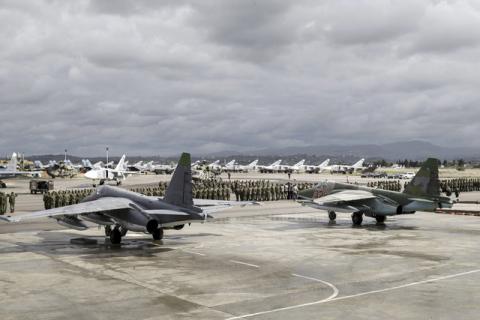Russian and Syrian servicemen line up near military jets during a ceremony dedicated to the withdrawal of Russian troops from Syria at Hmeymim airbase, Syria, March 15, 2016. PHOTO BY REUTERS/Vadim Grishankin