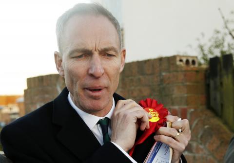 Scotland's Labour Party leader Jim Murphy puts on a Labour Party badge while campaigning in Dundee, Scotland, January 19, 2015. PHOTO BY REUTERS/Russell Cheyne