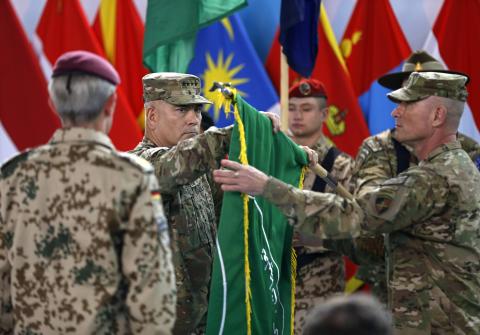 U.S. General John Campbell (C), commander of NATO-led International Security Assistance Force (ISAF), folds the flag of the ISAF during the change of mission ceremony in Kabul, December 28, 2014. PHOTO BY REUTERS/Omar Sobhani