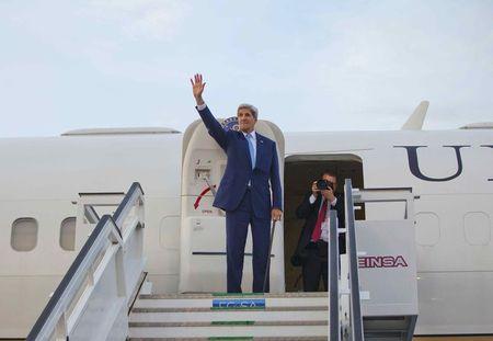 U.S. Secretary of State John Kerry waves from the top of the stairs before boarding his aircraft for his departure at Jose Marti International Airport in Havana, Cuba, August 14, 2015. PHOTO BY REUTERS/Pablo Martinez Monsivais