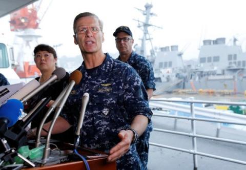 Vice Admiral Joseph Aucoin, U.S. 7th Fleet Commander, speaks to media on the status of the U.S. Navy destroyer USS Fitzgerald (seen behind him), damaged by colliding with a Philippine-flagged merchant vessel, and the seven missing Fitzgerald crew members, at the U.S. naval base in Yokosuka, south of Tokyo, Japan, June 18, 2017. PHOTO BY REUTERS/Toru Hanai