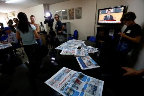 A journalist of pro-Kurdish Ozgur Gundem gives an interview to a German TV channel at their newsroom before a protest against the arrest of three prominent campaigners for press freedom, in front of the pro-Kurdish Ozgur Gundem newspaper in central Istanbul, Turkey, June 21, 2016. PHOTO BY REUTERS/Murad Sezer