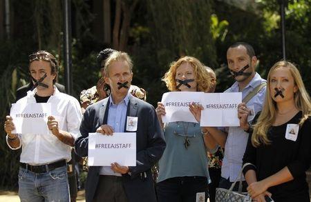 Kenya-based foreign journalists demonstrate against the imprisonment of three Al Jazeera journalists in Egypt, at the United Nations Environment programme (UNEP) headquarters in Nairobi January 13, 2015, as a reception by Egypt's Foreign Minister Sameh Shoukry took place nearby. PHOTO BY REUTERS/Thomas Mukoya