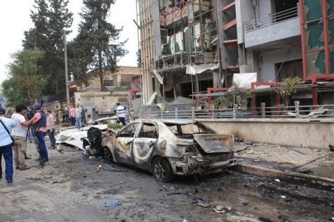 Journalists and civilians stand near the damage after rockets fired by insurgents hit the al-Dabit maternity clinic in government-held parts of Aleppo city, Syria, May 3, 2016. PHOTO BY REUTERS/SANA