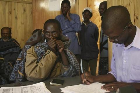 Former Lesotho gold miner Kalakune Marake registers with a legal clerk in a district office in Semongkong, 120 km (75 miles) east of the capital Maseru, January 12, 2012. PHOTO BY REUTERS/Ed Cropley