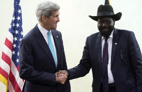 South Sudan's President Salva Kiir Mayardit (R) shakes hands with U.S. Secretary of State John Kerry at the President's Office in Juba