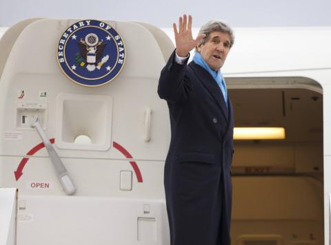 U.S. Secretary of State John Kerry waves as he boards his plane to return to the U.S., at Le Bourget Airport