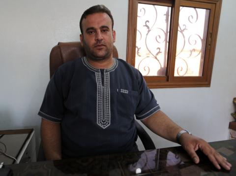 Khaled Dayamous, 33, owner of a woven mat factory poses in his office in Idlib province, Syria, July 29, 2018. PHOTO BY REUTERS/Khalil Ashawi
