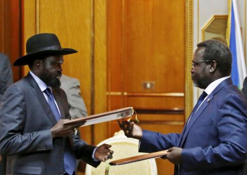 outh Sudan's rebel leader Riek Machar (R) and South Sudan's President Salva Kiir exchange signed peace agreement documents in Addis Ababa, Ethiopia, May 9, 2014. PHOTO BY REUTERS/Goran Tomasev