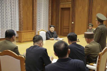 North Korean leader Kim Jong Un (back C) speaks at an emergency meeting of the Workers' Party of Korea (WPK) Central Military Commission, in this undated photo released by North Korea's Korean Central News Agency (KCNA) in Pyongyang, August 21, 2015. PHOTO BY REUTERS/KCNA