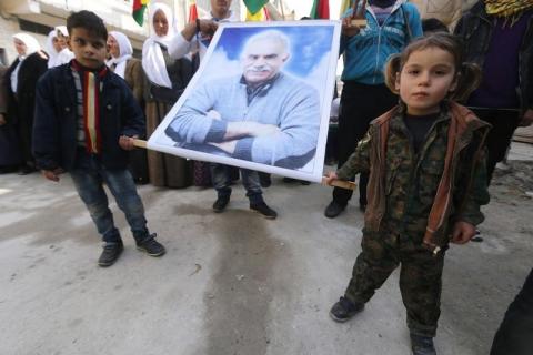 Kurdish children carry a picture of Abdullah Ocalan, jailed leader of the Kurdistan Workers' Party (PKK), during a celebration after it was reported that Kurdish forces took control of the Syrian town of Kobani, in Sheikh Maksoud neighborhood of Aleppo, January 27, 2015. PHOTO BY REUTERS/Hosam Katan