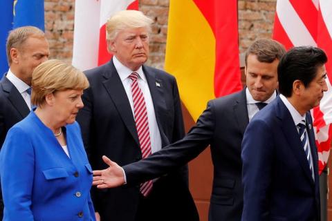 From L-R, European Council President Donald Tusk, German Chancellor Angela Merkel, U.S. President Donald Trump, French President Emmanuel Macron and Japanese Prime Minister Shinzo Abe walk after a family photo during the G7 Summit in Taormina, Sicily, Italy, May 26, 2017. PHOTO BY REUTERS/Jonathan Ernst