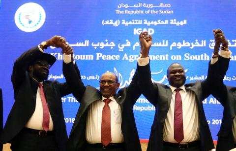 South Sudan President Salva Kiir (L), Sudan's President Omar Al-Bashir (C) and South Sudan rebel leader Riek Machar hold hands after signing a peace agreement aimed to end a war in which tens of thousands of people have been killed, in Khartoum, Sudan, June 27, 2018. PHOTO BY REUTERS/Mohamed Nureldin Abdallah