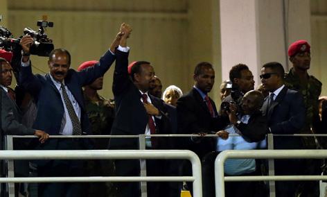 Eritrea's President Isaias Afwerki and Ethiopian Prime Minister Abiy Ahmed hold hands during a concert at the Millennium Hall in Addis Ababa, Ethiopia, July 15, 2018. PHOTO BY REUTERS/Tiksa Negeri