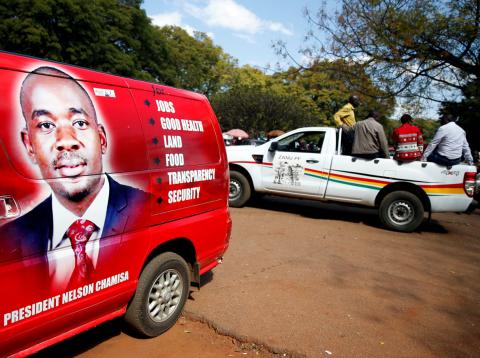 Vehicles display the logos for Zimbabwean opposition Movement For Democratic Change (MDC) party, and the ruling ZANU PF party outside an election nomination court in Harare, Zimbabwe, June 14, 2018. PHOTO BY REUTERS/Philimon Bulawayo