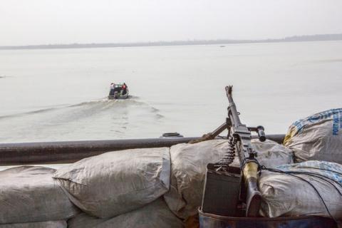 A machine gun is seen on a sandbag on a boat off the Atlantic coast in Nigeria's Bayelsa state, December 19, 2013. PHOTO BY REUTERS/Stringer