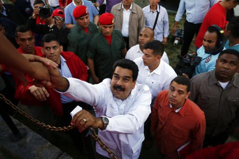 Venezuela's President Nicolas Maduro greets suporters as he arrives at a rally with workers in Caracas
