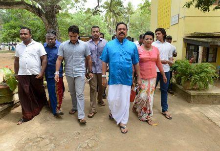 Sri Lanka's former President Mahinda Rajapaksa (3rd R) arrives at a polling station during the general election in Medamulana, August 17, 2015. PHOTO BY REUTERS/Stringer