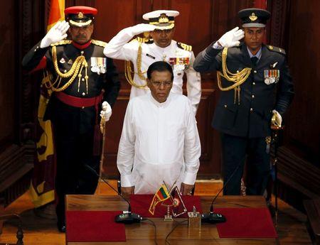 Sri Lanka's President Maithripala Sirisena (front) stands for the national anthem during a ceremony to swear in Ranil Wickremesinghe, leader of the United National Party, as Sri Lanka's new prime minister in Colombo, August 21, 2015. PHOTO BY REUTERS/Dinuka Liyanawatte