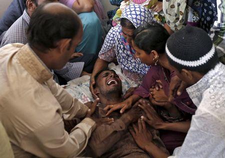 A Muslim man (C) weeps after getting the news of his family members, who died in Thursday's stampede in Mina, at their residence in Ahmedabad, India, September 25, 2015. PHOTO BY REUTERS/Amit Dave