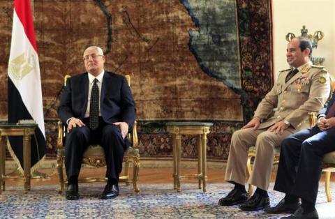 Egypt's interim President Adly Mansour (L) and Army Chief General Abdel Fattah al-Sisi attend a meeting with Russia's Defence Minister Sergei Shoigu and Foreign Minister Sergei Lavrov (not pictured) at El-Thadiya presidential palace