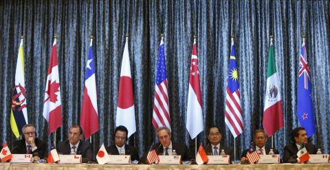U.S. Trade Representative Michael Froman (C) speaks next to Japan's Economics Minister Akira Amari (centre L) and Singapore's Trade Minister Lim Hng Kiang (centre R), amongst trade ministers representing Canada, Peru, Malaysia and Mexico during a news conference at the end of a four-day Trans-Pacific Partnership (TPP) Ministerial meeting in Singapore