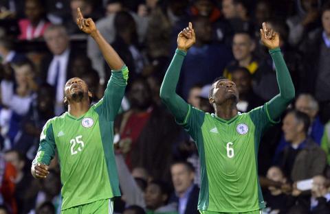 Nigeria's Michael Uchebo (L) celebrates scoring against Scotland with teammate Azubuike Egwuekwe during their international friendly soccer match at Craven Cottage in London