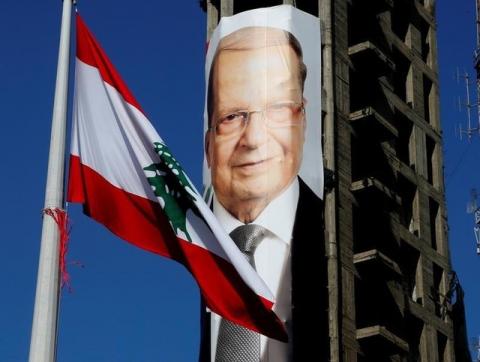 A Lebanese flag flutters near a picture of Christian politician and FPM founder Michel Aoun on a building prior to presidential elections in Beirut, Lebanon, October 30, 2016. PHOTO BY REUTERS/Mohamed Azakir
