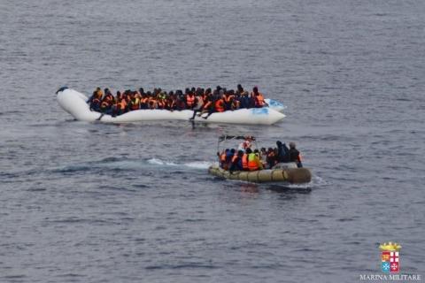 Migrants sit in their boat during a rescue operation of 219 migrants by Italian naval vessel Bettica (not seen) in this February 23, 2016. PHOTO BY REUTERS/Marina Militare
