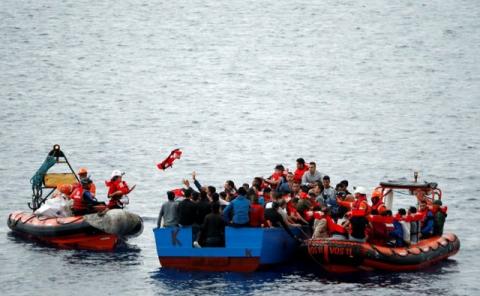 Migrants on a wooden boat are rescued by "Save the Children" NGO crew from the ship Vos Hestia in the Mediterranean sea off Libya coast, June 18, 2017. PHOTO BY REUTERS/Stefano Rellandini