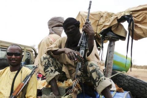 Militiamen from the Ansar Dine Islamic group sit on a vehicle in Gao in northeastern Mali, June 18, 2012. PHOTO BY REUTERS/Adama Diarra