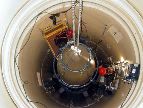 A US Air Force missile maintenance team removes the upper section of an intercontinental ballistic missile with a nuclear warhead in an undated USAF photo at Malmstrom Air Force Base, Montana. PHOTO BY REUTERS/USAF/Airman John Parie