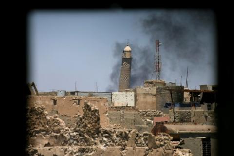 Al-Hadba minaret at the Grand Mosque is seen through a building window in the old city of Mosul, Iraq, June 1, 2017. PHOTO BY REUTERS/Alaa Al-Marjani