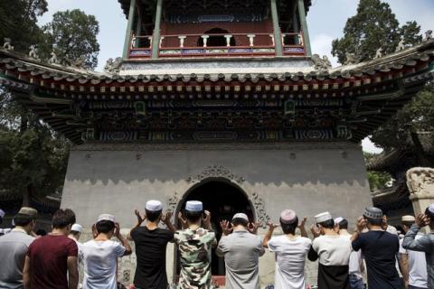 Muslim believers pray at the historic Niujie mosque as they celebrate the Eid al-Fitr in Beijing, July 18, 2015. PHOTO BY REUTERS/Damir Sagolj