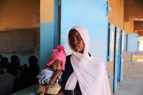 Mouna Issahk poses for a portrait with her daughter at her school in Touloum refugee camp, Iriba, Chad, November 27, 2019. PHOTO BY Thomson Reuters Foundation/Nellie Peyton