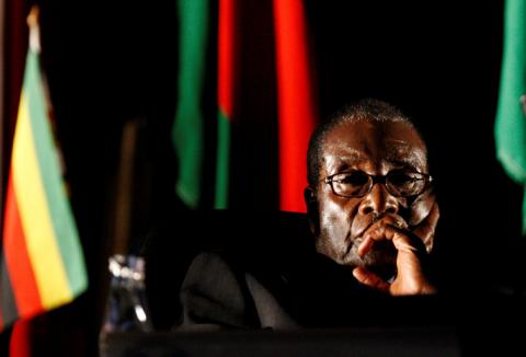Former Zimbabwean President Robert Mugabe watches a video presentation during the summit of the Southern African Development Community (SADC) in Johannesburg, August 17, 2008. PHOTO BY REUTERS/Mike Hutchings